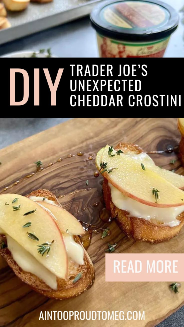 two pieces of bread with cheese and apples on them, sitting on a cutting board