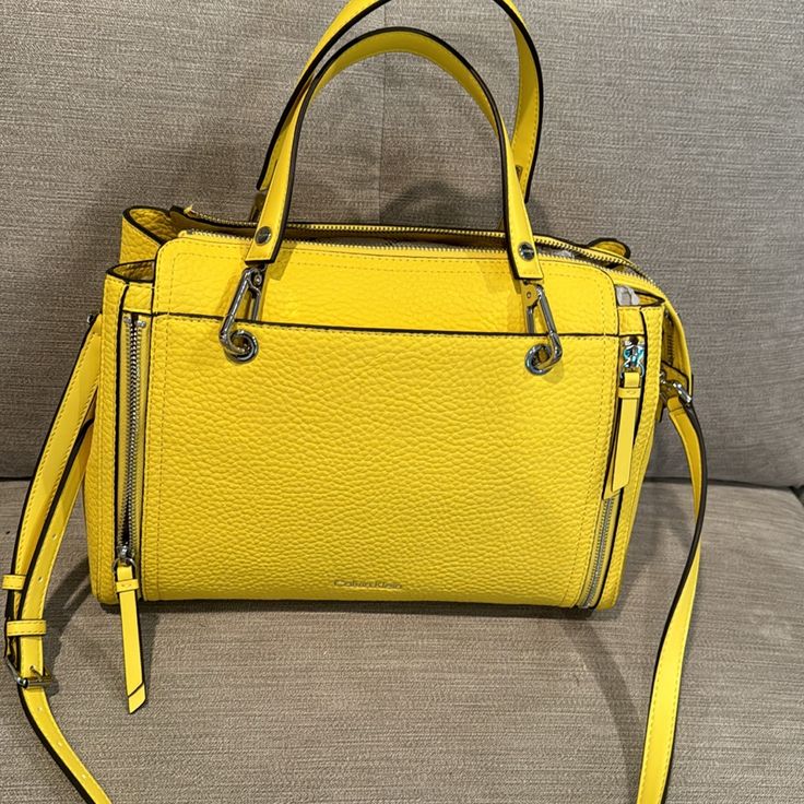 Selling A Yellow Calvin Klein Purse Which Is 9’ From Top To Bottom And 13’ Long It Has Several Compartments For Good Organization And It Has Silver Hardware . It Is A Really Nice Banana Color Yellow. Calvin Klein Leather Bag For On-the-go, Modern Calvin Klein Satchel Bag, Calvin Klein Rectangular Shoulder Bag With Zipper Closure, Calvin Klein Satchel Shoulder Bag With Zipper, Calvin Klein Satchel With Top Carry Handle, Calvin Klein Rectangular Leather Satchel, Calvin Klein Rectangular Leather Bag, Calvin Klein Leather Rectangular Bag, Calvin Klein Leather Bag With Top Handle