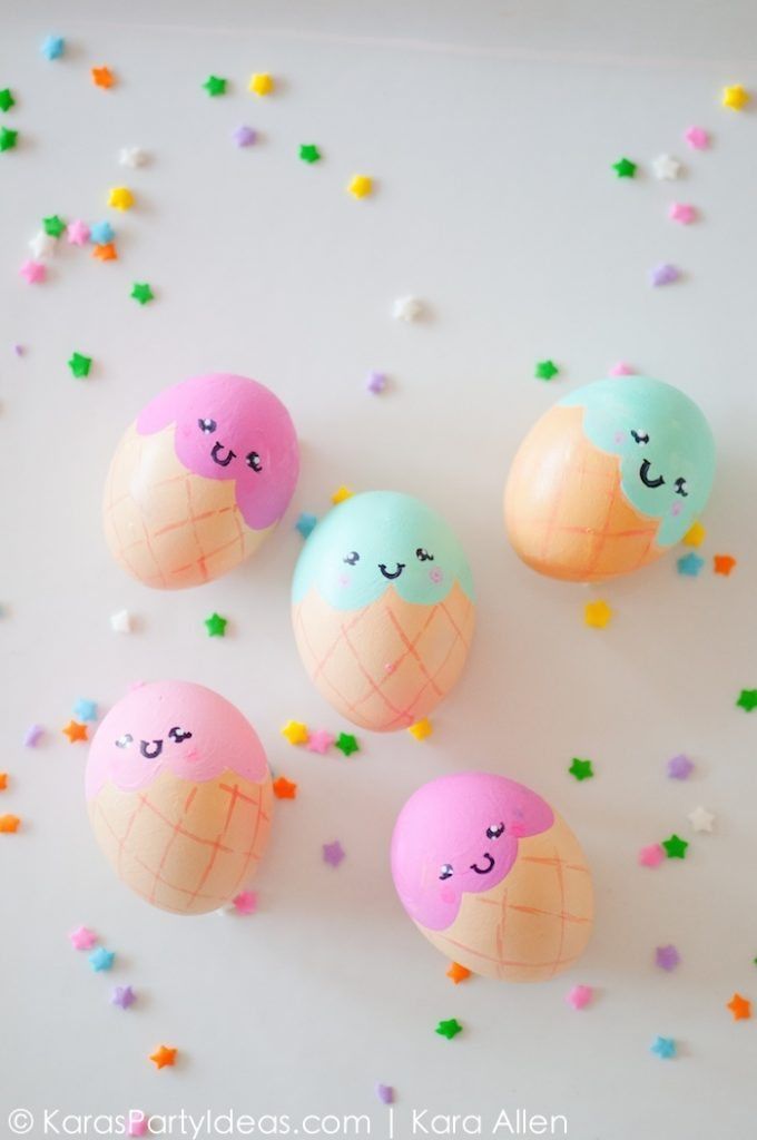 four decorated eggs with faces on them and confetti sprinkles around them