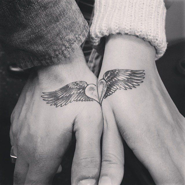 two hands holding each other with tattoos on their palms and the words i give you my everything, you've given me these loving wings