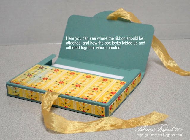 an open box with a ribbon tied around it