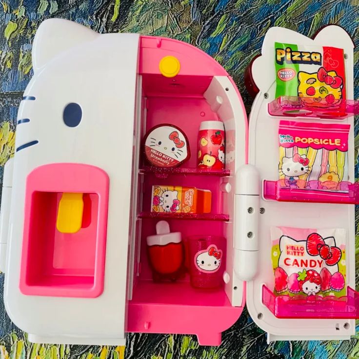 an open hello kitty toy refrigerator with various items in it