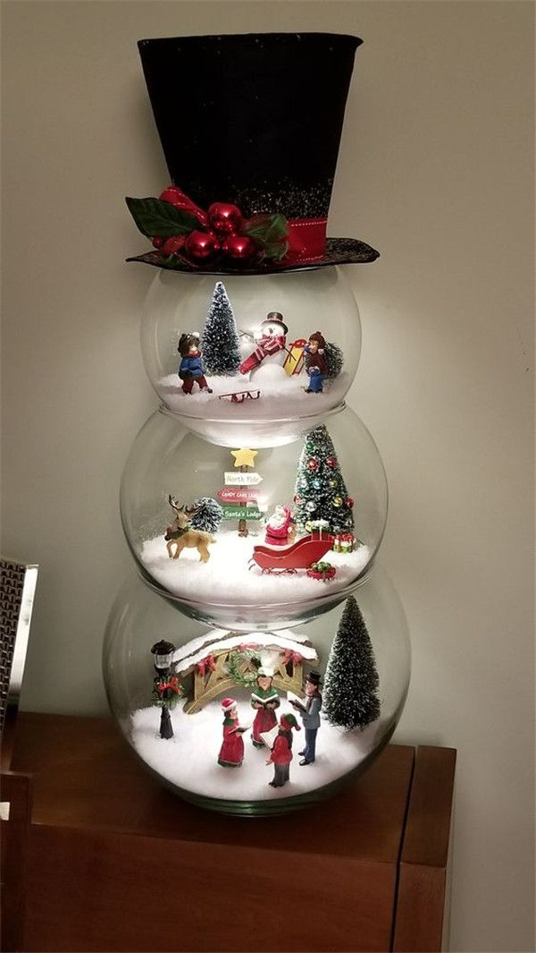 three snow globes with christmas decorations on them