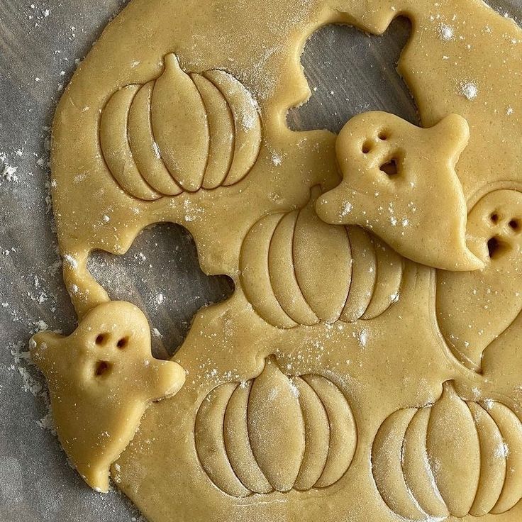 pumpkin shaped cookies on a cookie sheet with icing