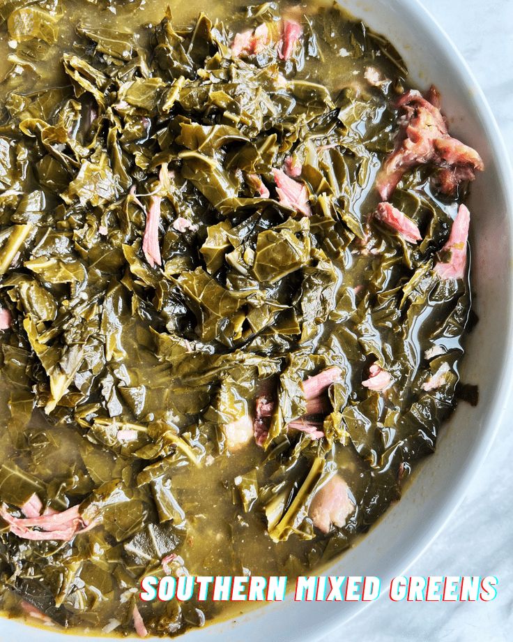 a white bowl filled with greens and meat