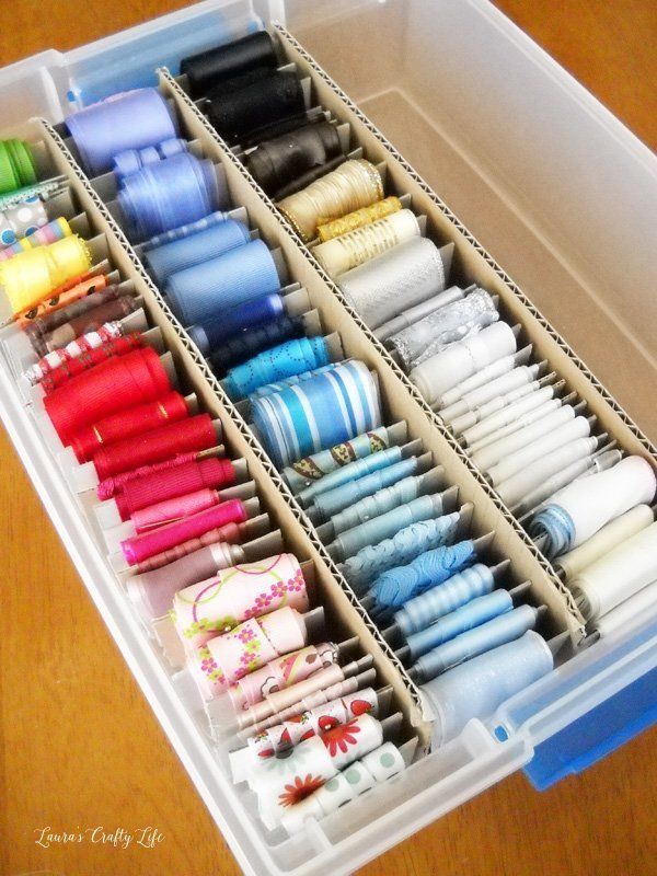 a plastic container filled with lots of different types of thread