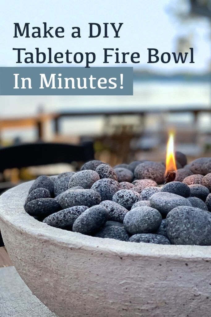 a fire bowl filled with rocks sitting on top of a table