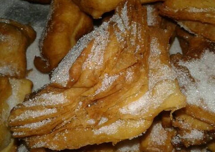 powdered sugar covered pastries sitting in a box