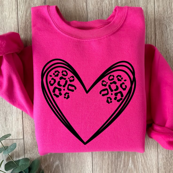 Leopard heart tee or crewneck is such a cute and simple design to make a big impact. Choose any color to make it pop.  Size up one for a baggier oversized fit. These shirts are made to order so you get exactly what you want. Join our fb group for specials: https://www.facebook.com/groups/708500593017136/?ref=share Oversized Heart Graphic T-shirt With Crew Neck, Casual Pink T-shirt With Heart Print, Oversized Heart Graphic Crew Neck T-shirt, Oversized Crew Neck T-shirt With Heart Graphic, Pink Long Sleeve T-shirt With Heart Graphic, Pink T-shirt For Everyday Fall Wear, Pink Everyday T-shirt For Fall, Everyday Pink T-shirt For Fall, Trendy Valentine's Day Crew Neck T-shirt