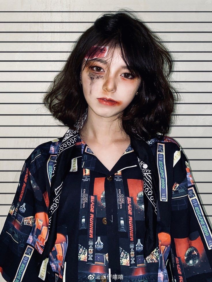 a woman with makeup on her face standing in front of a mugshot wallpaper