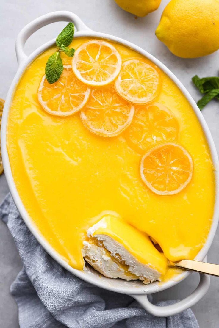 a bowl filled with lemon custard soup on top of a table