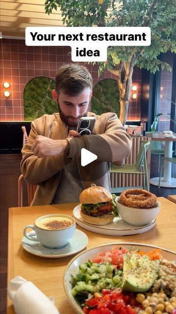 a man taking a photo of food on his cell phone with the caption'your next restaurant idea '