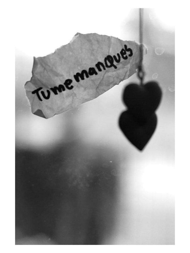 a piece of paper with the words tume manques written on it hanging from a string