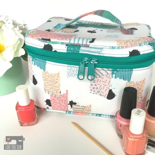 an open suitcase with nail polish and manicures in it next to a flower