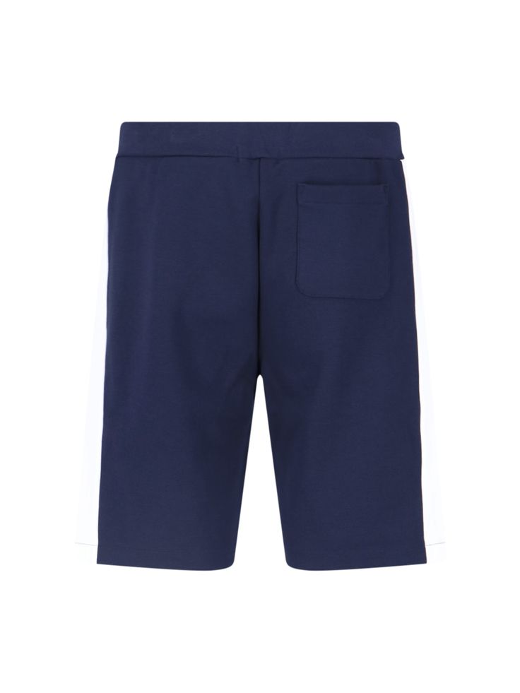 Polo Ralph Lauren logo sporty shorts in a blue cotton blend, with white side band detailing, an elastic waistband, a drawstring closure, two side pockets, tone-on-tone embroidered logo at the front, a back welt pocket, and white logo embroidery at the front. Ralph Lauren Trousers, Sporty Shorts, Ralph Lauren Logo, Equestrian Style, Engineered Garments, Shop Logo, Sneaker Brands, Luxury Shop, Logo Embroidery