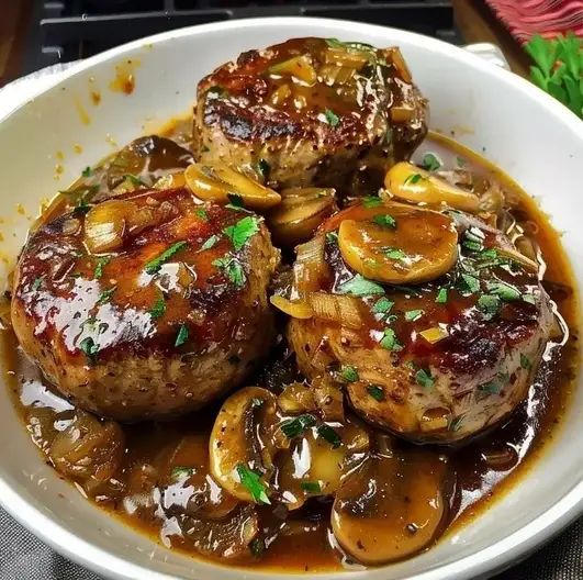 a white bowl filled with meat covered in mushroom gravy