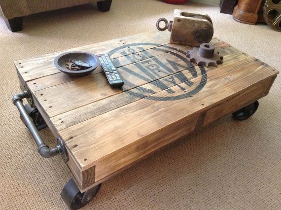 a coffee table made out of pallet wood with wheels on the bottom and an iron plate on top