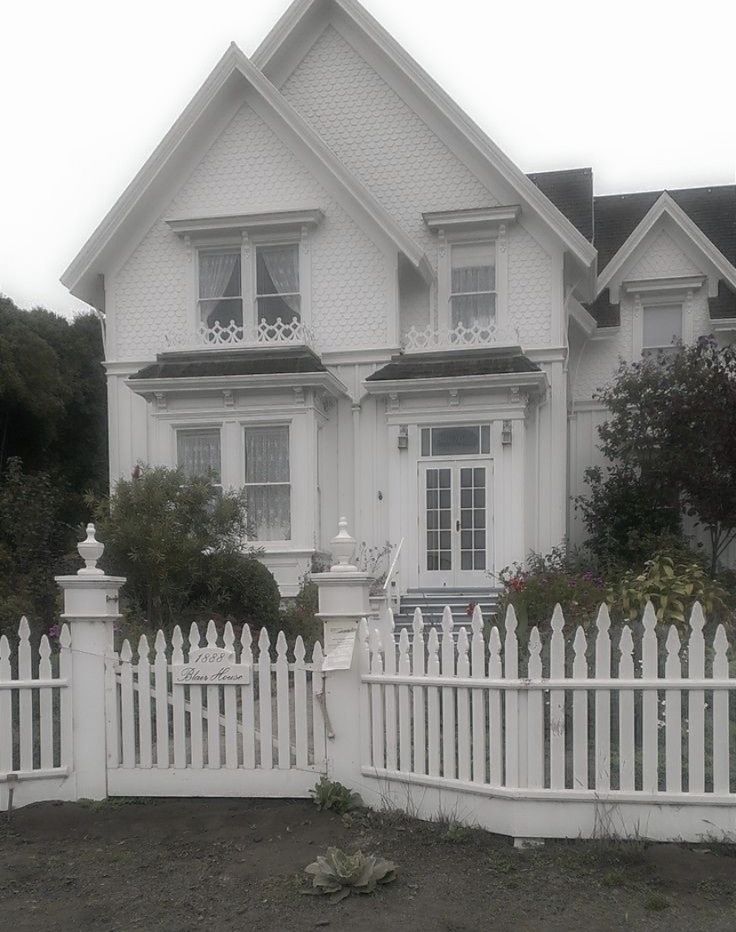 a white picket fence in front of a house