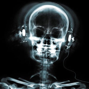 a skeleton with headphones in its ear and an x - ray image behind it