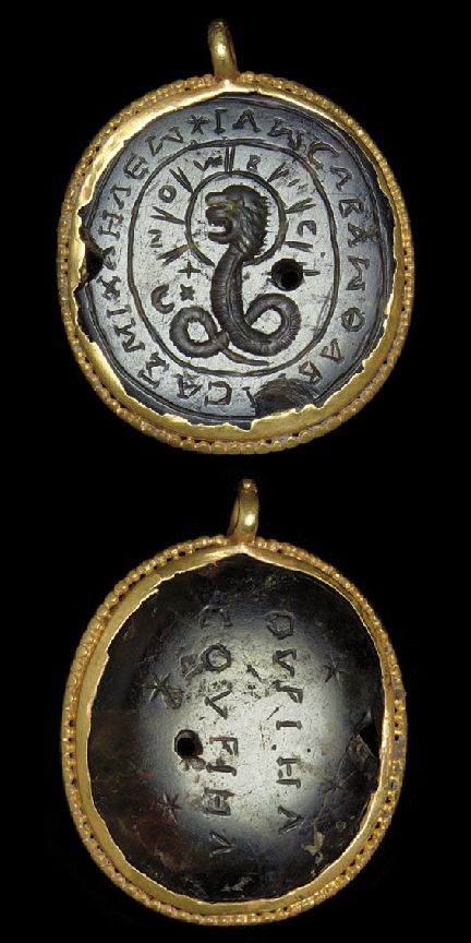 two silver and gold pendants with writing on the bottom one has a snake in it's center