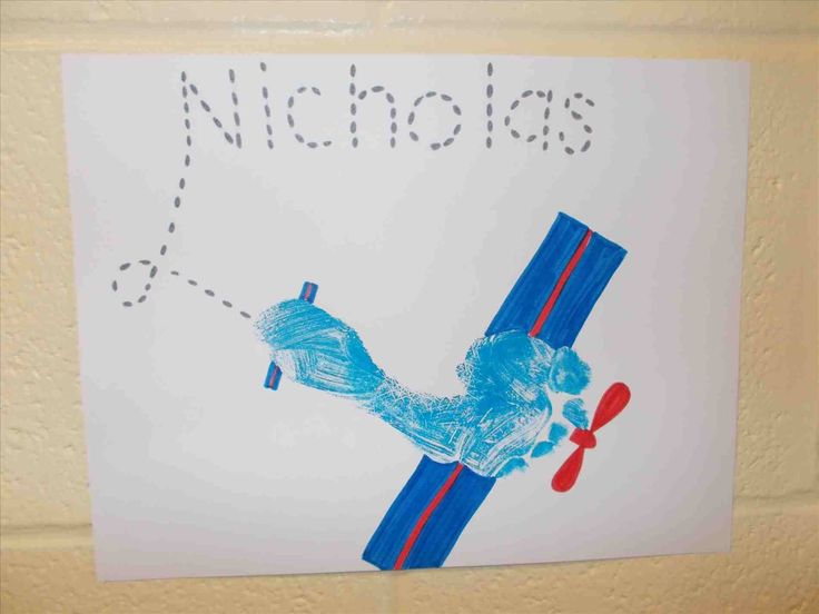 a child's drawing of a blue dog on a white paper with the word nicholas above it