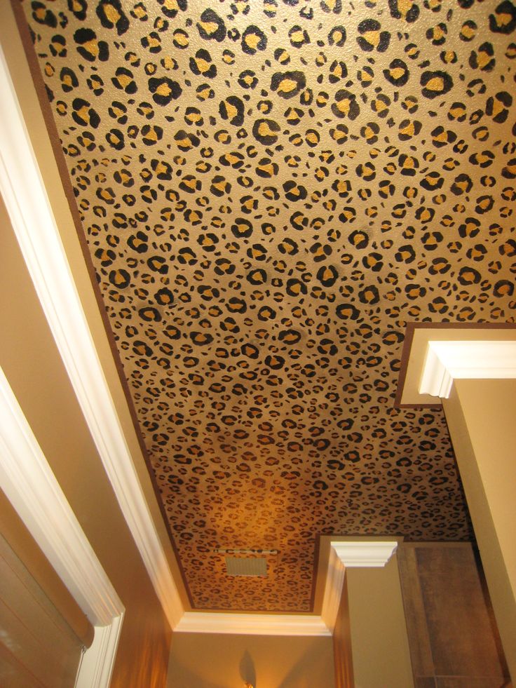 a bathroom with a leopard print wallpaper on the ceiling