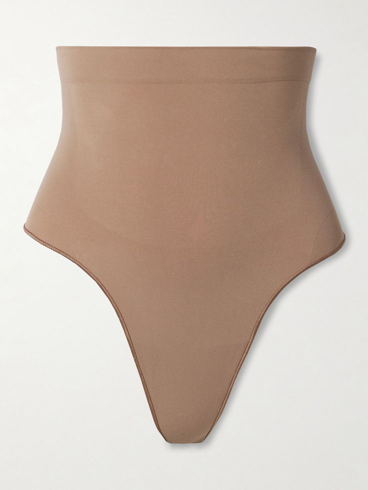 Part of the 'Seamless Sculpt' line, SKIMS' thong is made from sculpting stretch fabric that offers the brand's 'Strong' level of support. It features a high waist that hits just below the bust and has an internal silicone strip to keep it in place. High Cut Stretch Shapewear With Seamless Construction, High Cut Stretch Seamless Shapewear, High Stretch High Cut Seamless Swimwear, High Stretch Seamless High Cut Swimwear, Seamless High Stretch High Cut Swimwear, High Stretch Seamless High-cut Swimwear, Seamless Sculpting High-cut Leg Shapewear, Contoured Seamless Solid Shapewear, High Cut Micro-elastic Smoothing Swimwear