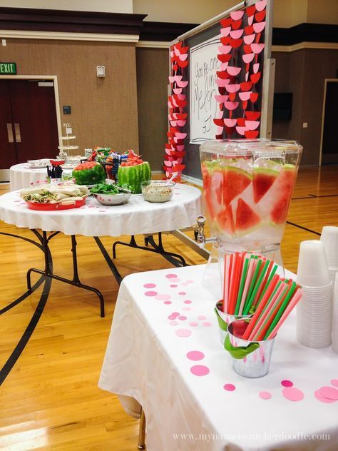 a table topped with lots of food and drinks on top of a hard wood floor