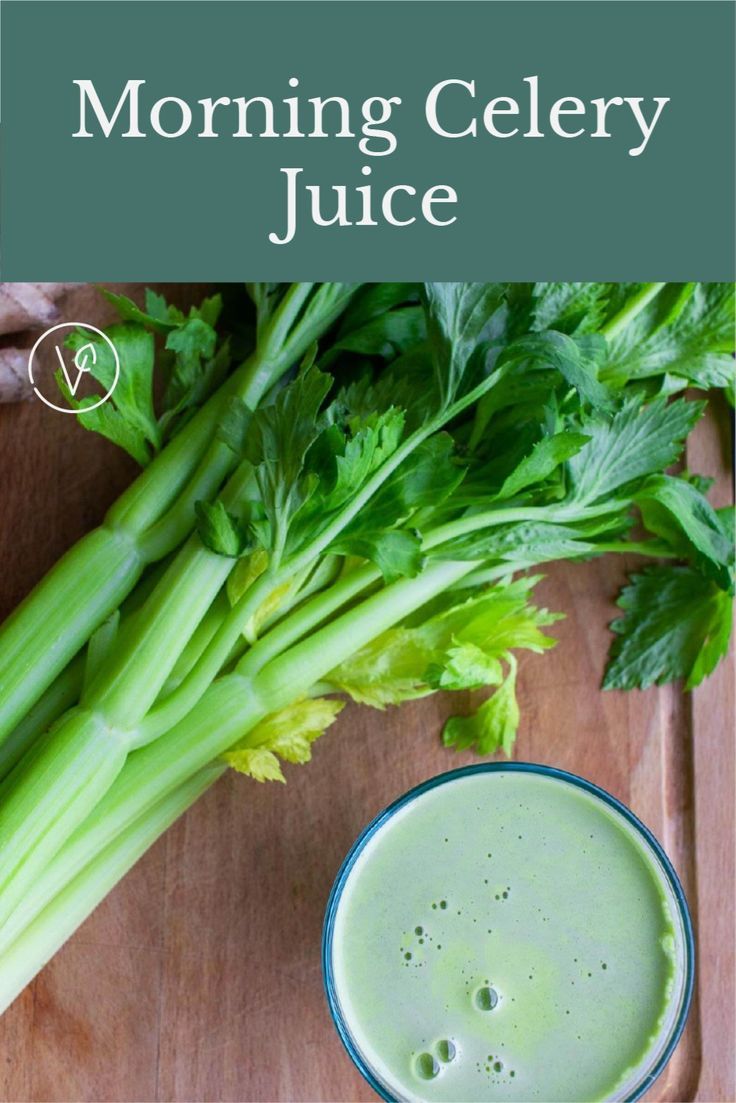 celery juice in a blue bowl next to some celery stalks