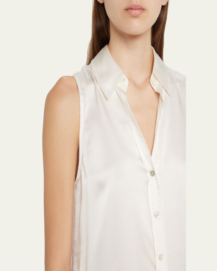 L'Agence "Emmy" lustrous blouse finished with tonal buttons     Spread collar; button front    Sleeveless    Yoked back    Relaxed fit    Shirttail hem    Silk    Dry clean    Imported Elegant Sleeveless Blouse For Daywear, Classic Sleeveless Formal Blouse, Elegant Sleeveless Top With Back Button Closure, Elegant Button-up Summer Tank Top, Formal Sleeveless Tops With Buttons, Elegant Button-up Tank Top For Summer, Chic Sleeveless Top With Back Button Closure, Sleeveless Silk Padded Blouse, Classic Sleeveless Blouse With Buttons