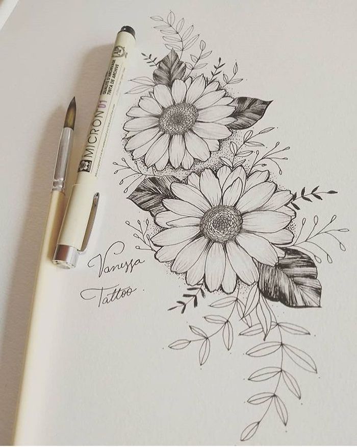 a drawing of some flowers on a piece of paper next to a marker and pen