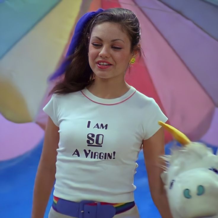 a woman in white shirt holding an umbrella and a stuffed animal next to her face