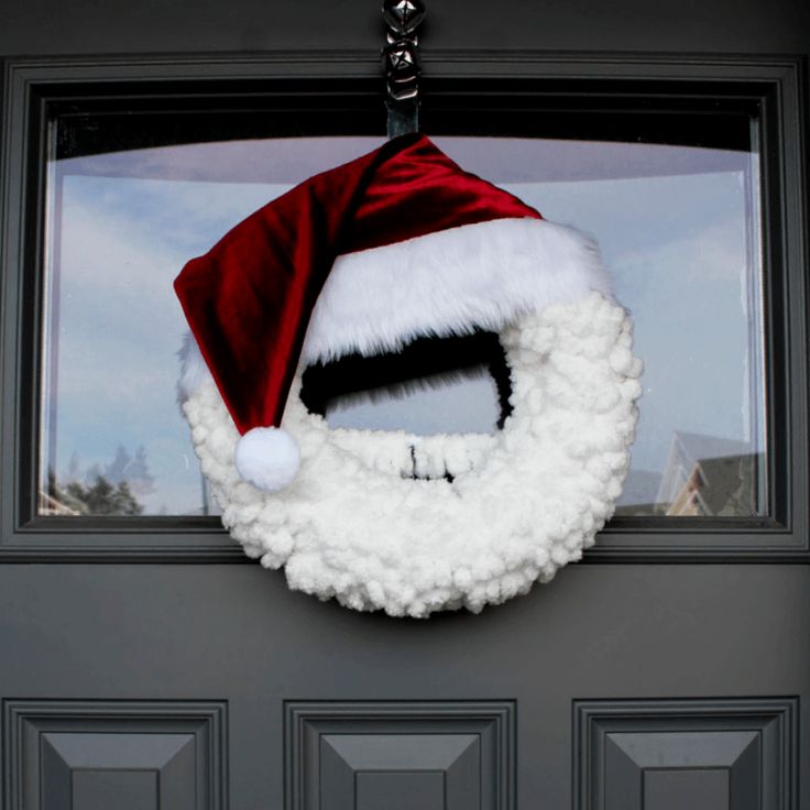 a santa claus hat hanging on the front door