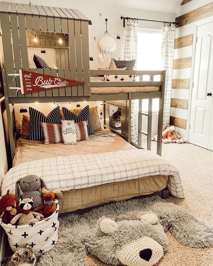 a child's bedroom with a bunk bed and stuffed animals on the floor in front of it