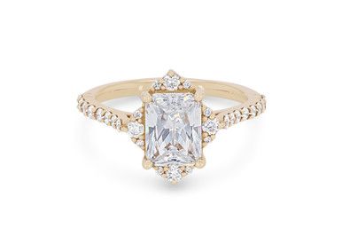 an 18k yellow gold engagement ring with a cushion cut diamond