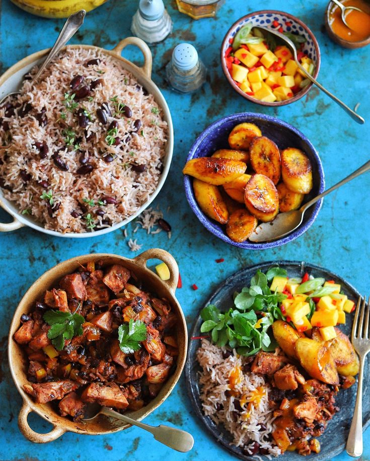 a table topped with bowls filled with different types of food next to plates and utensils