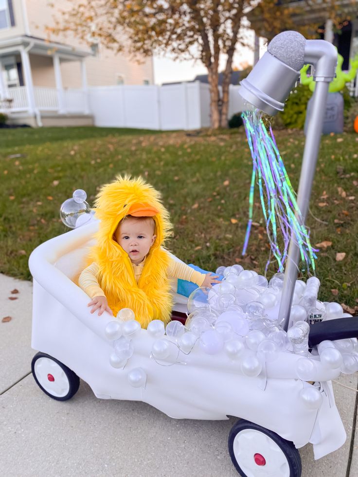 a small child in a toy wagon with bubbles