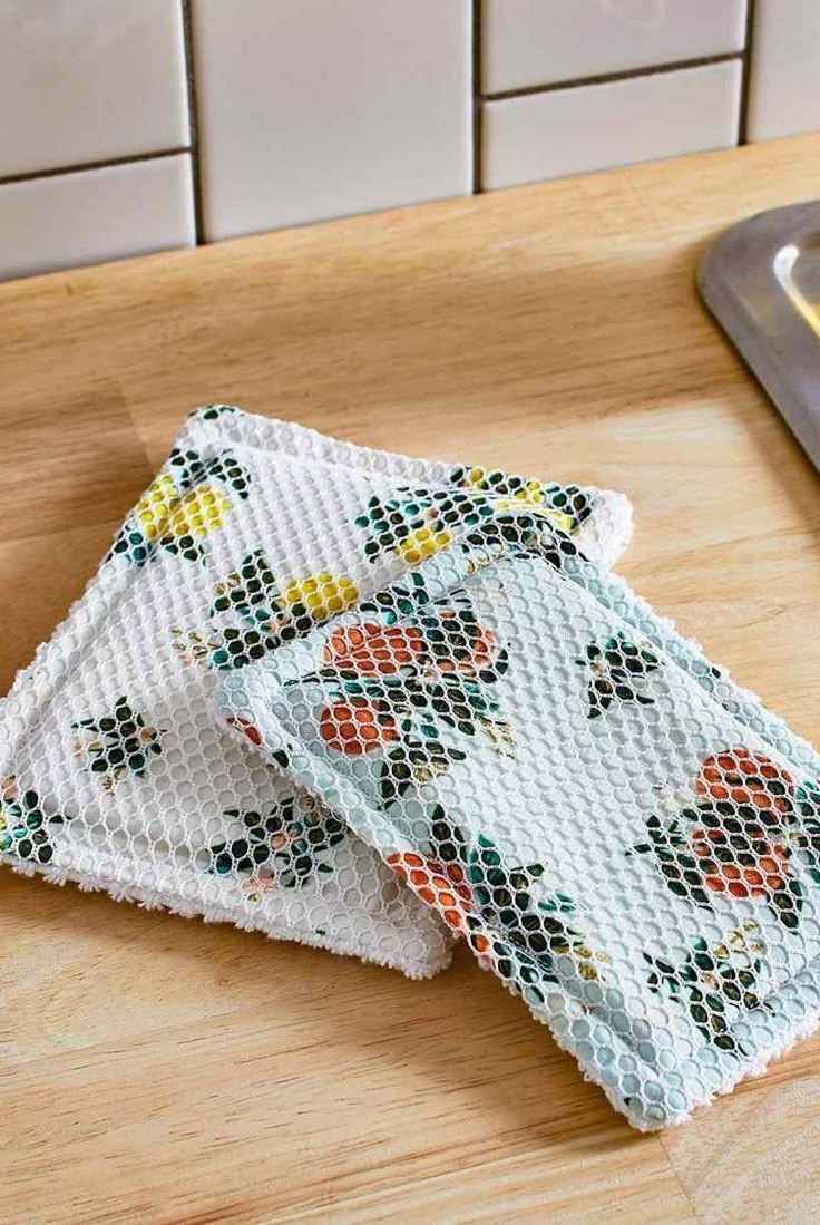 two pieces of cloth sitting on top of a wooden counter