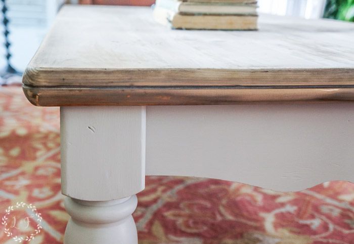 a white table with books on top of it and a red carpet in the background