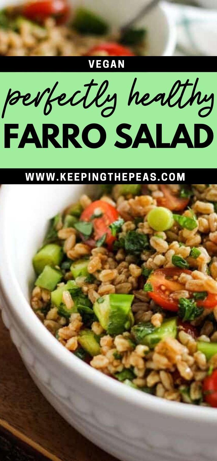 a white bowl filled with faro salad on top of a wooden table