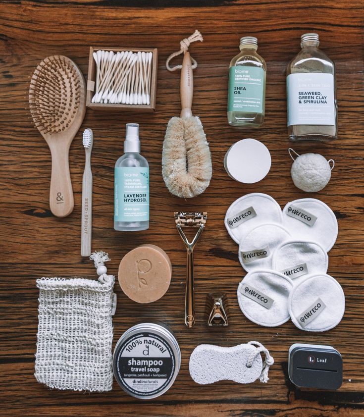 the contents of a personal care kit laid out on a table with soap, toothbrushes, and other items