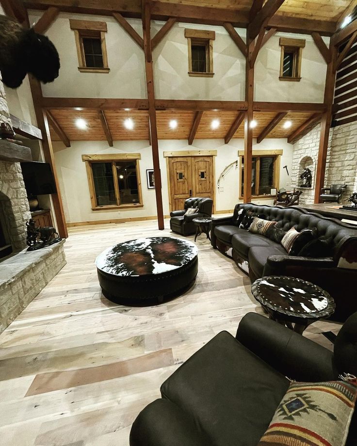 a living room filled with lots of furniture and a fire place in the middle of it