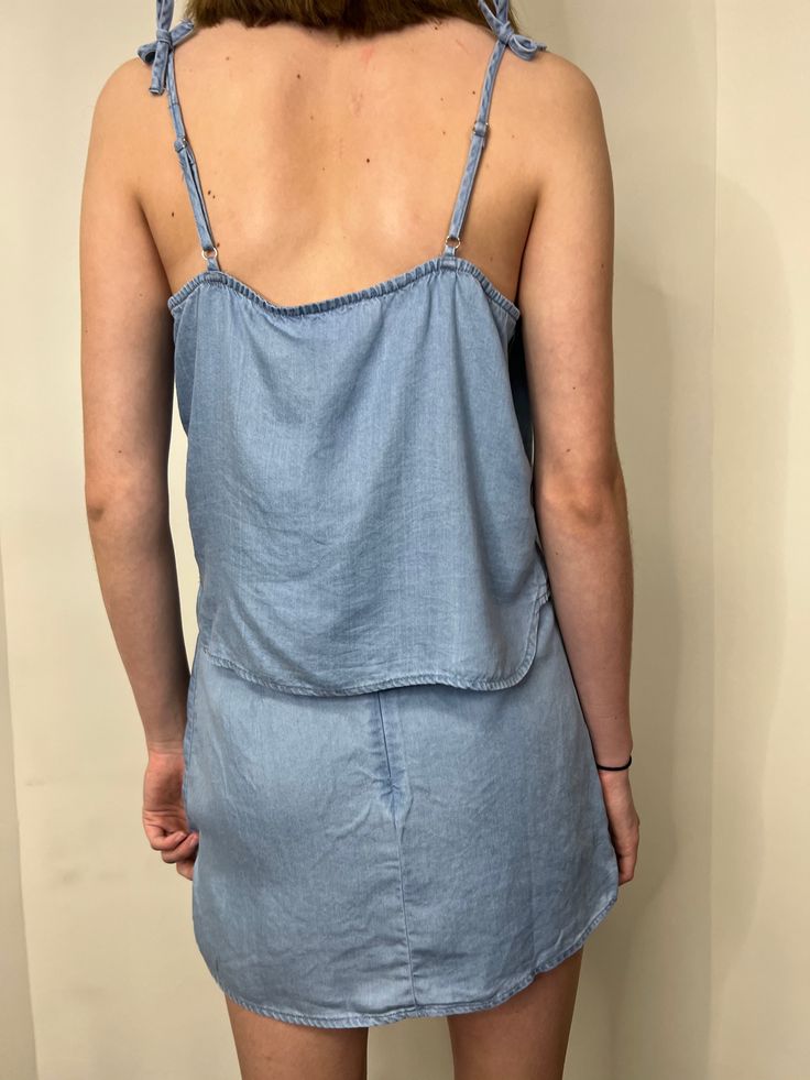 get ready to breeze through summer with our tween soft breeze chambray tank! this playful, chambray tank is part of our tween collection and is perfect for those sunny vacations. pair it with our matching soft breeze chambray wrap skirt for an effortless and stylish look! ﻿pair with our matching soft breeze chambray wrap skirt! shop more of our tween apparel!!! sizing, details & care sizingJetta is 5'5" wearing a large details-100% tencel care- hand wash cold- do not bleach- line dry- cool iron if needed Light Blue Relaxed Fit Denim Top For Summer, Summer Relaxed Fit Denim Blue Denim Top, Light Wash Denim Top For Summer Day Out, Light Wash Top For Beach In Summer, Summer Washed Denim Tops, Light Wash Summer Beach Top, Summer Denim Washed Tops, Summer Cotton Tank Camisole, Summer Denim Top For Day Out