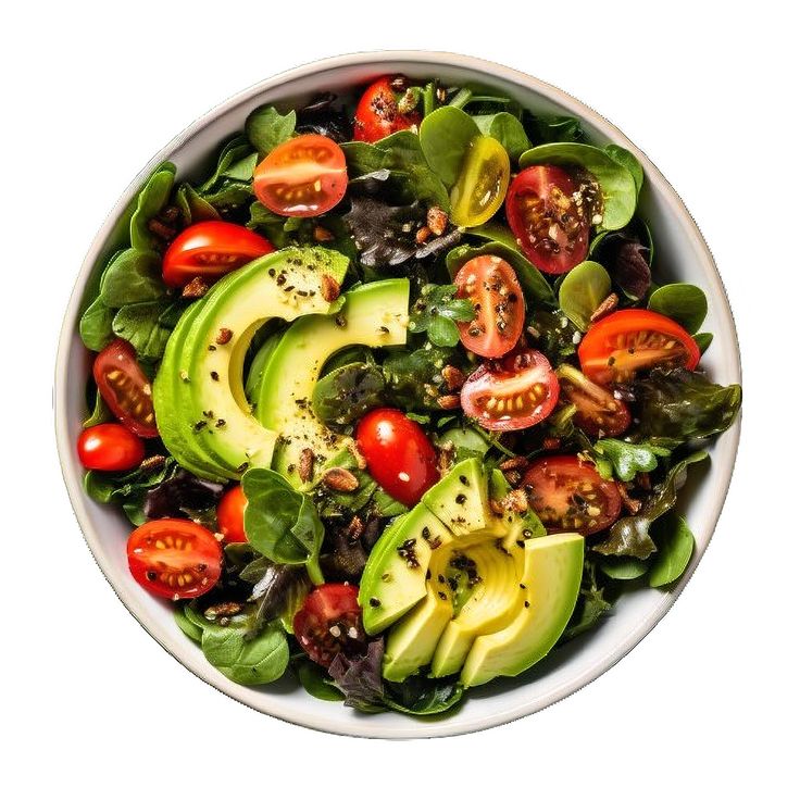 a salad with avocado, tomatoes and spinach in a white bowl on a white background