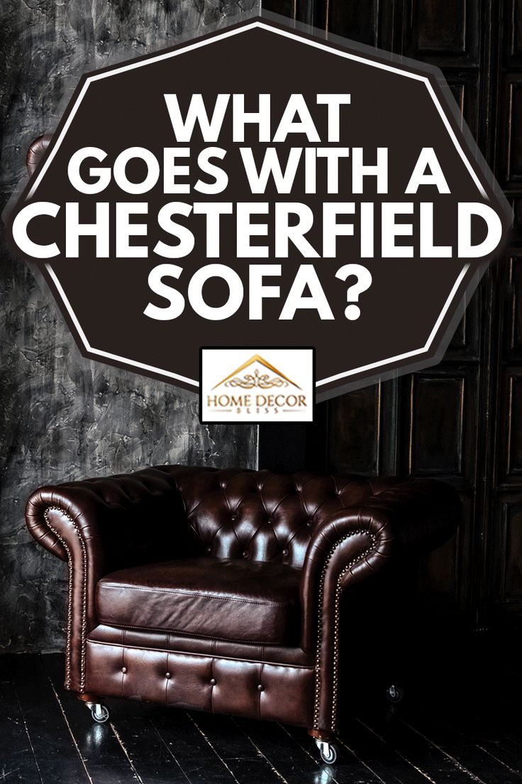 a brown leather chair sitting in front of a black wall with the words what goes with a chesterfield sofa?