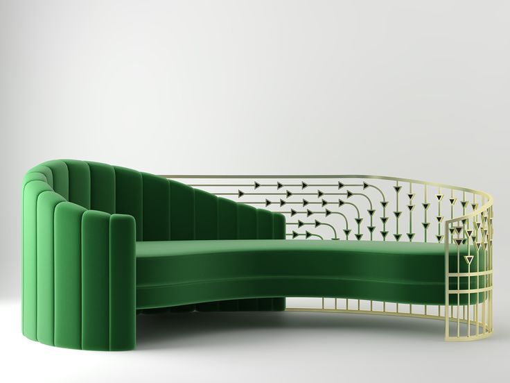 a green couch sitting on top of a white floor next to a metal frame wall