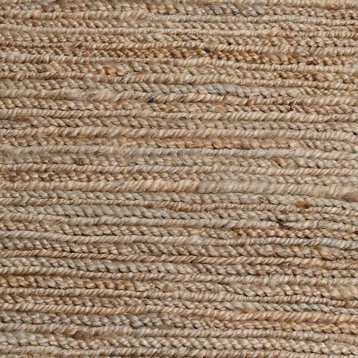 the texture of an area rug with brown and tan colors, including braided ends