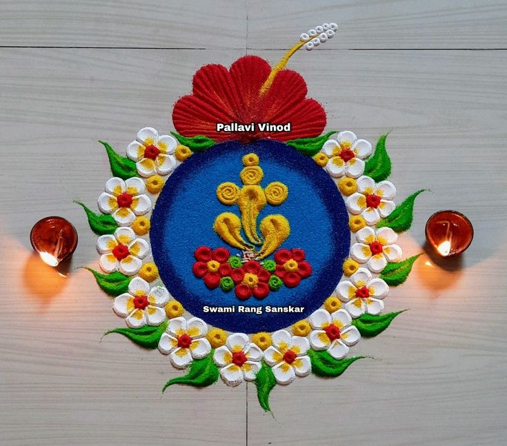 an intricately decorated wall hanging with flowers and candles in the center on a wooden floor