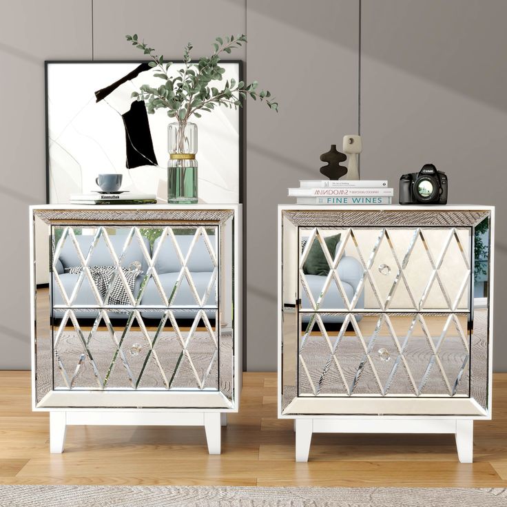 two mirrored nightstands sitting on top of a wooden floor