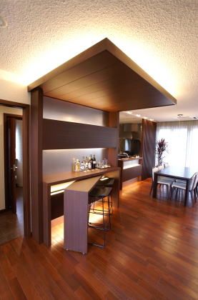 an open kitchen and dining room with wood flooring in a modern house or apartment